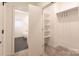 A Walk-in closet and ensuite bathroom with modern fixtures and shelving at 2107 W Trade St, Charlotte, NC 28216