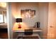 A tidy bedroom or office space with a desk and artwork on the wall at 230 S Tryon St # 304, Charlotte, NC 28202
