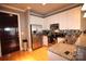 A modern kitchen with stainless steel appliances, granite countertops, and hardwood floors at 230 S Tryon St # 304, Charlotte, NC 28202