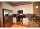 Kitchen featuring stainless steel appliances, granite countertops, tile backsplash, and hardwood floors at 230 S Tryon St # 304, Charlotte, NC 28202