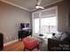 Comfortable living room with balcony access, ceiling fan, neutral walls and wood floors at 230 S Tryon St # 304, Charlotte, NC 28202