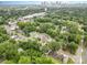 Residential neighborhood aerial view with lush greenery and a clear view of the city skyline in the distance at 2312 Tate St, Charlotte, NC 28216