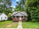 Inviting home with a classic front porch and well-maintained lawn, perfect for relaxing outdoors at 2312 Tate St, Charlotte, NC 28216