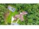 Aerial view of the home and property surrounded by lush, mature trees at 307 E Allenton St, Mount Gilead, NC 27306