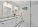 This bathroom boasts double sinks with granite countertops and a subway tile shower at 307 E Allenton St, Mount Gilead, NC 27306