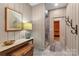 Spa-like bathroom featuring wood paneling and a modern shower, with natural lighting creating a relaxing atmosphere at 307 E Allenton St, Mount Gilead, NC 27306