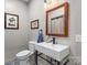 Modern bathroom featuring a white vanity sink, mirror, and gray walls at 307 E Allenton St, Mount Gilead, NC 27306