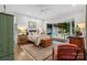 This room features a king-sized bed, hardwood floors, and an attached sunroom at 307 E Allenton St, Mount Gilead, NC 27306
