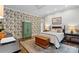 A bright bedroom with floral wallpaper and a hardwood floor at 307 E Allenton St, Mount Gilead, NC 27306