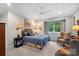 This bedroom features carpet, a large window with trees, and two chairs at 307 E Allenton St, Mount Gilead, NC 27306