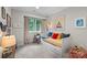 Neutral bedroom with daybed, window overlooking trees, and coastal-themed decor, creating a serene atmosphere at 307 E Allenton St, Mount Gilead, NC 27306