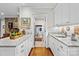 Well-lit kitchen area with granite counters, white cabinets, and doorway to laundry at 307 E Allenton St, Mount Gilead, NC 27306