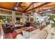 Comfortable living room with hardwood floors, vaulted wood ceiling, and large windows at 307 E Allenton St, Mount Gilead, NC 27306