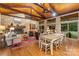 Inviting living room featuring a stone fireplace, wood ceiling, and an open dining area at 307 E Allenton St, Mount Gilead, NC 27306