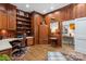 Wood paneled office space with wood flooring, desk and ample built-in shelving at 307 E Allenton St, Mount Gilead, NC 27306