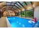 Indoor pool under vaulted glass roof, offering a luxurious and private aquatic experience with natural light and spacious design at 307 E Allenton St, Mount Gilead, NC 27306
