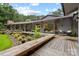 Back exterior with a multi-level deck, garden, and hanging porch swing at 307 E Allenton St, Mount Gilead, NC 27306