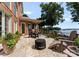 Beautiful backyard patio with dining set, outdoor lounge chair, fire pit, and lake views at 3996 Channel Point Ln, Denver, NC 28037