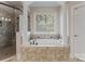 Bathroom featuring a soaking tub surrounded by decorative tile at 3996 Channel Point Ln, Denver, NC 28037