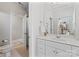 Clean, neutral bathroom with vanity, large mirror, and visible entrance to shower/toilet area at 3996 Channel Point Ln, Denver, NC 28037