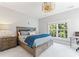 Bright bedroom featuring a large bed, natural light from window, and unique gold ceiling fan at 3996 Channel Point Ln, Denver, NC 28037