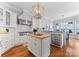Gourmet kitchen featuring a central island, stainless steel appliances, and picturesque water views at 3996 Channel Point Ln, Denver, NC 28037