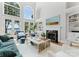Bright living room with high ceilings, arched windows, fireplace, and elegant furnishings at 3996 Channel Point Ln, Denver, NC 28037