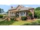 Rear exterior of brick home with patio dining, lush lawn, and mature landscaping at 3996 Channel Point Ln, Denver, NC 28037