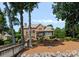 Wide shot of red brick home from the rear, featuring lush backyard, and treelined views at 3996 Channel Point Ln, Denver, NC 28037