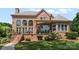 Brick home's rear exterior features large windows, a covered patio, and well-maintained landscaping at 3996 Channel Point Ln, Denver, NC 28037
