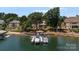 Lakefront home with a private dock, boat slips, and lush green surroundings at 3996 Channel Point Ln, Denver, NC 28037