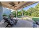 Covered back porch with outdoor seating and a grill, ideal for relaxing and enjoying the views at 4113 Bent Green Ln, Monroe, NC 28112