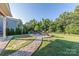 The backyard has a fire pit and a stone walkway, offering a peaceful retreat at 4113 Bent Green Ln, Monroe, NC 28112