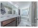 Bright bathroom with double sinks, a soaking tub, and a separate glass-enclosed shower at 4113 Bent Green Ln, Monroe, NC 28112