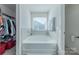 Relaxing bathroom featuring a large soaking tub next to a sunny window at 4113 Bent Green Ln, Monroe, NC 28112