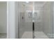 Modern bathroom featuring a glass-enclosed shower with tiled walls and a built-in shelf at 4113 Bent Green Ln, Monroe, NC 28112