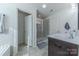 Well-lit bathroom featuring a shower, bathtub, and double sink vanity with dark cabinets at 4113 Bent Green Ln, Monroe, NC 28112