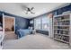 Well-lit bedroom featuring a bookcase, carpet floors, and natural light from the window at 4113 Bent Green Ln, Monroe, NC 28112