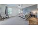 Inviting bedroom features a ceiling fan, a stylish accent wall, and a cozy seating area at 4113 Bent Green Ln, Monroe, NC 28112
