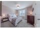 Cozy bedroom featuring neutral carpet, soft decor, and a large window providing natural light at 4113 Bent Green Ln, Monroe, NC 28112