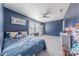 Cozy bedroom featuring blue walls, carpet flooring, and a ceiling fan at 4113 Bent Green Ln, Monroe, NC 28112