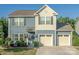 Charming two-story home with a three car garage, light blue siding and a welcoming front porch at 4113 Bent Green Ln, Monroe, NC 28112