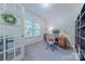 Bright home office with built-in bookshelves, a comfortable desk, and an exterior view at 4113 Bent Green Ln, Monroe, NC 28112