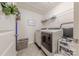 Efficient laundry room with modern washer and dryer, ample shelving, and storage solutions at 4113 Bent Green Ln, Monroe, NC 28112