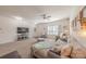 Bright living room with a large sectional couch, ceiling fan, and natural light at 4113 Bent Green Ln, Monroe, NC 28112