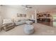 Open-concept living room with neutral carpet and paint, flowing into the dining area and kitchen at 4113 Bent Green Ln, Monroe, NC 28112