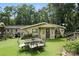 An eye-level shot showcases the back of the home with an outdoor dining set on an artificial lawn at 4412 Dobys Bridge Rd, Fort Mill, SC 29707