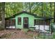 Green, wood-sided exterior with a black door and two screened in porch areas under a black shingled roof at 4412 Dobys Bridge Rd, Fort Mill, SC 29707