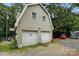 Detached two-car garage, offering ample parking and storage space, set among mature trees at 4412 Dobys Bridge Rd, Fort Mill, SC 29707