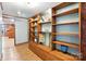 An eye-level view of a blue hallway with a rustic floor-to-ceiling bookshelf at 4412 Dobys Bridge Rd, Fort Mill, SC 29707